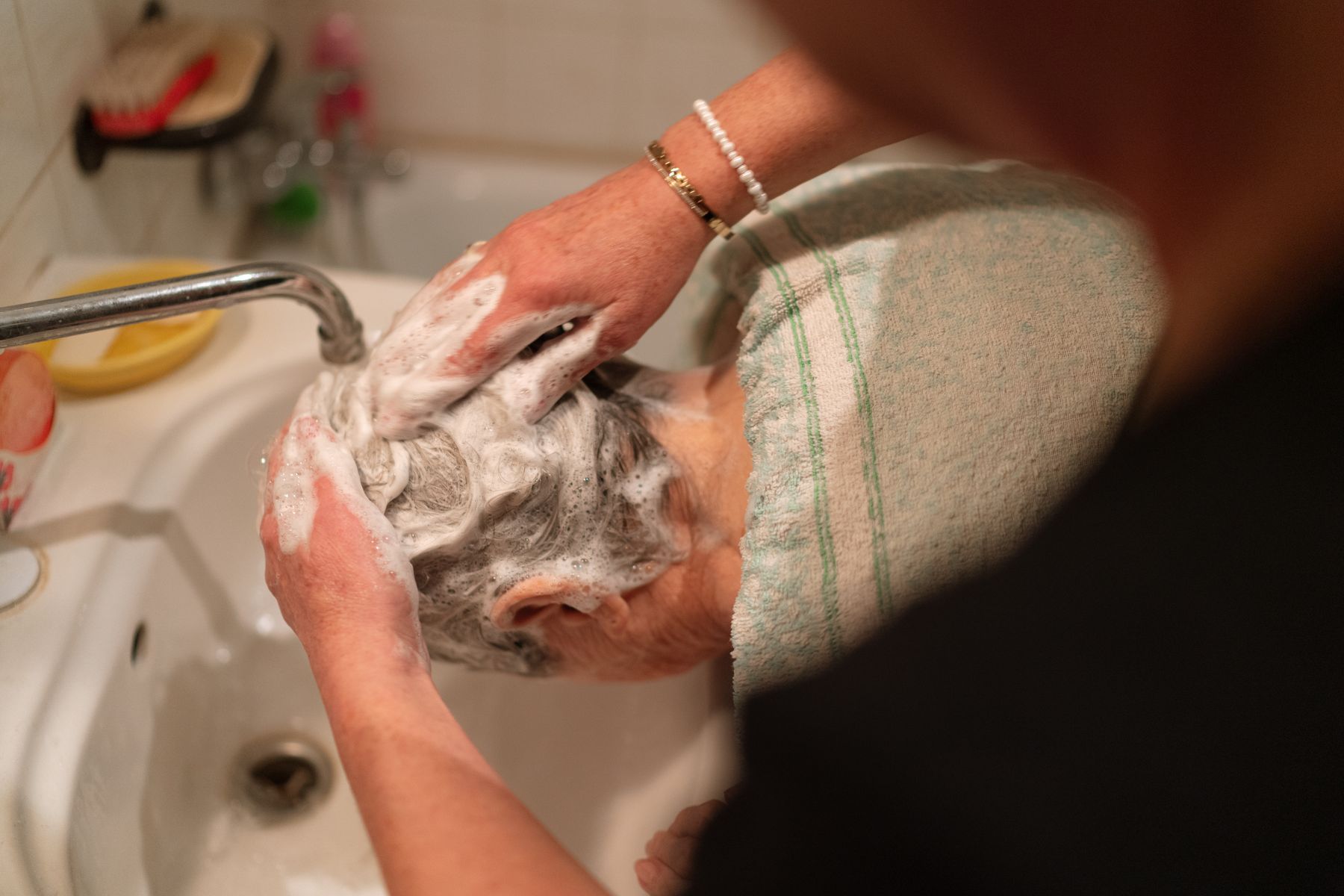 Hair being washed at a sink
